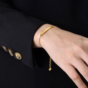 Adjustable gold stainless steel chain bracelet with curved bar and heart pendant