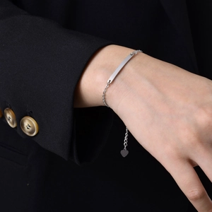 Polished stainless steel ID bracelet for women with custom engraving plate and heart charm