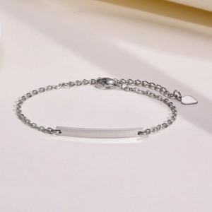 Adjustable stainless steel chain bracelet with curved engravable plate and heart charm