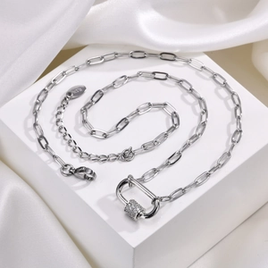 Macro shot of silver carabiner pendant necklace with micro-pave cubic zirconia detail