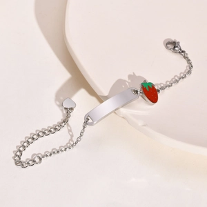 Close-up of a stainless steel bracelet with a blank bar and strawberry charm