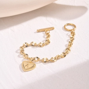 Detail of 14K gold plated heart charm with letter A on an OT toggle chain bracelet
