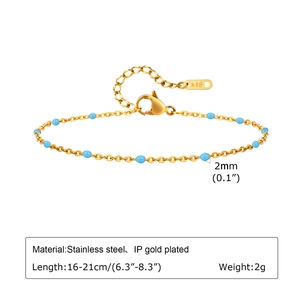Detailed view of gold stainless steel link bracelet with 2mm turquoise beads and lobster clasp