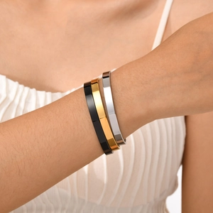 Three-piece minimalist cuff bracelets set in black, gold, and silver polished finishes
