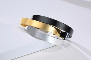 Polished stainless steel open cuff bracelets in gold, black, and silver metallic finishes
