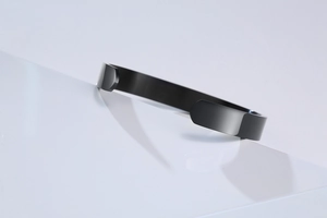 Macro side view of black polished stainless steel cuff bangle with a smooth mirror finish