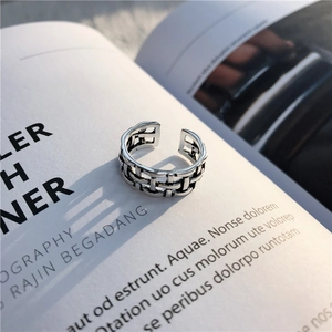 Detail of vintage silver adjustable open ring with intricate woven mesh hollow texture