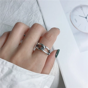 Detalle de un anillo de nudo de plata S925 vintage en el dedo con fondo artístico