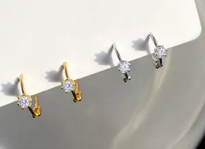 Detalle de pendientes de plata 925 con circonitas de seis garras en oro y plata