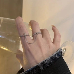 Minimalist silver cross chain double ring set with small diamonds worn on finger