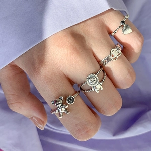 Retro S925 silver lion and bear ring set with heart charms on a silk background