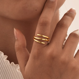 Minimalist gold-plated triple-layer spiral open ring worn on a finger for daily fashion