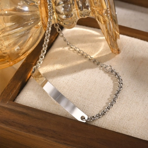 Macro detail of silver stainless steel ID bracelet with flat engravable bar on round link chain