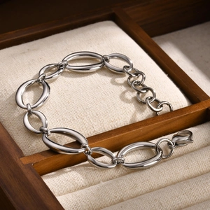 Gros plan d'un bracelet gourmette en acier inoxydable argenté avec fermoir mousqueton