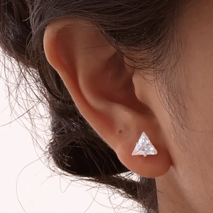 Minimalist triangle zirconia stud earrings in gold finish worn by a model