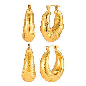 Golden stainless steel croissant hoop earrings with minimalist geometric textures on white base