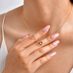 Elegant gold stainless steel sunflower necklace with zircon pendant worn by female model