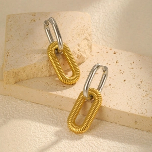 Detail of U-shape double hoop earrings with gold spiral texture and silver oval ring