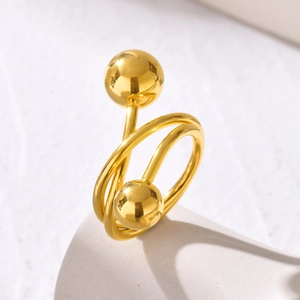 Minimalist gold double layer spiral coil ring with polished spheres on white stand