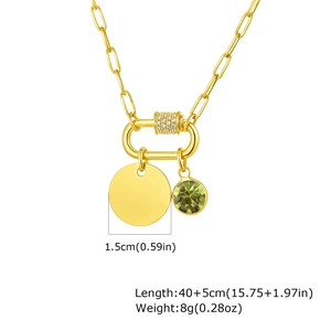 Detail of gold paperclip necklace with emerald pendant and engravable 1.5cm round disk