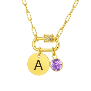 Detail of paperclip chain necklace with purple gemstone and engraved letter A pendant