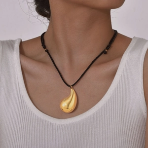 Polished 18K gold teardrop pendant necklace with adjustable black cord on model