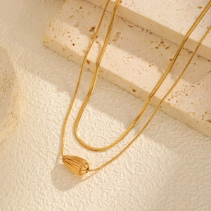 Double-layered gold snake chain necklace with a striped metal teardrop pendant