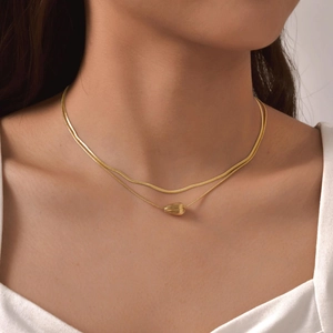 Double-layer gold stainless steel necklace featuring a striped waterdrop pendant on model