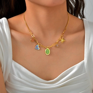 Gold stainless steel chain necklace with green opal and heart pendants on a female model