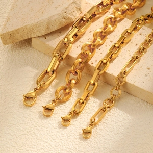 Gold stainless steel geometric link bracelets with lobster clasps on stone background