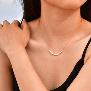 Minimalist gold stainless steel chain necklace with square shell beads on female model