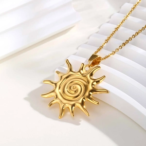 Macro detail of golden sun pendant with spiral texture on minimalist jewelry stand