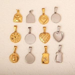 Macro display of assorted vintage heart and beetle charms in gold and silver finishes