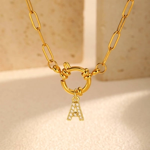 Macro view of gold-plated paperclip chain necklace with zircon-studded A-letter pendant