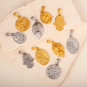 Variety of hip hop style lion and religious steel pendants on a natural stone base