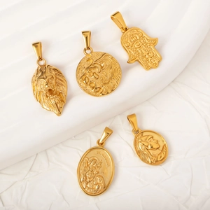Gold hip-hop stainless steel pendants featuring lion head and religious medals on white surface