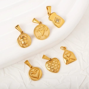Set of vintage golden stainless steel pendants featuring beetle and heart designs