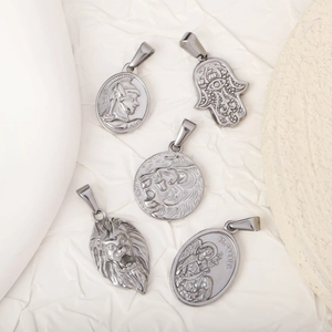 Five unique stainless steel hip hop pendants with lion and hamsa designs on white stone
