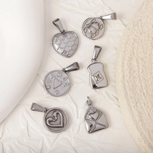 Retro stainless steel pendants featuring heart, beetle, and envelope designs in silver