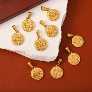 Detailed view of nine gold coin angel number pendants with sparkling rhinestone accents