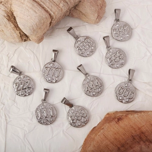 Macro display of nine silver angel number pendants with sparkling zircon stone accents