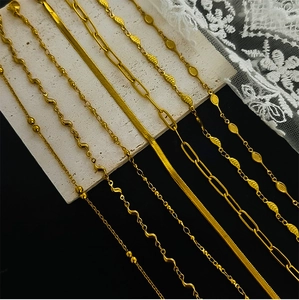 Detail view of seven golden stainless steel chain styles including bead and leaf designs