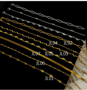 Detail view of seven gold and silver stainless steel chain anklets with lobster clasps