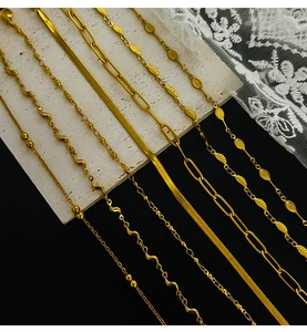 Detail of diverse gold plated stainless steel chains including leaf and bead designs