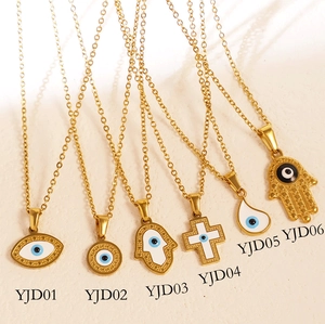 Flat lay of six gold-plated Evil Eye pendant necklaces in various vintage ethnic styles