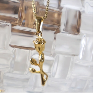 Detailed close-up of a golden 18K gold-plated stainless steel rose flower pendant necklace