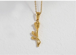 Detailed close-up of 18K gold plated stainless steel rose flower pendant on a classic link chain