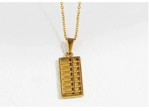 Macro detail of a 18K gold plated stainless steel abacus pendant with tiny movable beads
