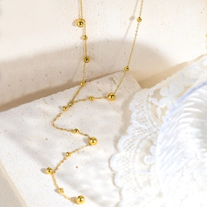 Collana vintage francese in acciaio al titanio placcato oro 18 carati con perle dorate