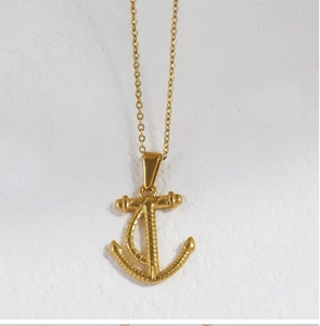 Detailed view of the 18K gold plated anchor pendant with textured metallic finish